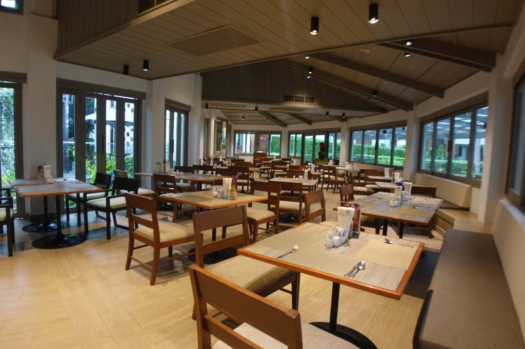 Indoor restaurant seating at Woodlands Hotel & Resort in Pattaya, Thailand.