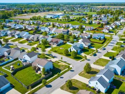 Neighborhood showing detached houses with gardens.