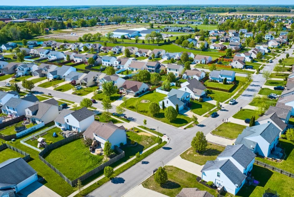 Neighborhood showing detached houses with gardens.