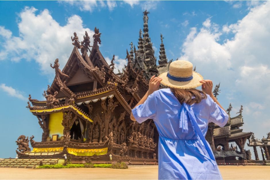 Tourist standing in front of Pattaya Sanctuary of Truth in Thailand.