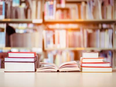Books arranged on a table in a library.