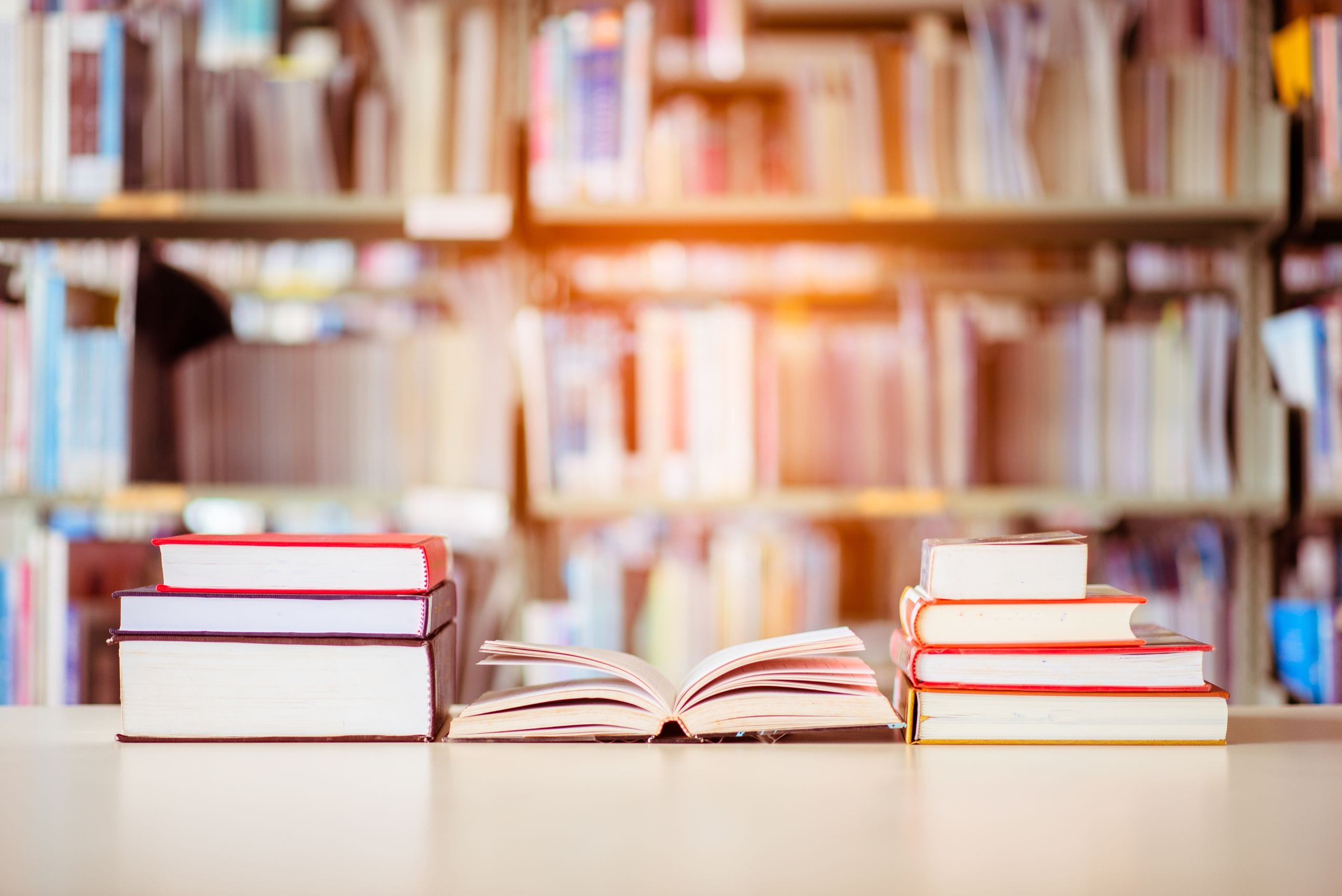 Books arranged on a table in a library.