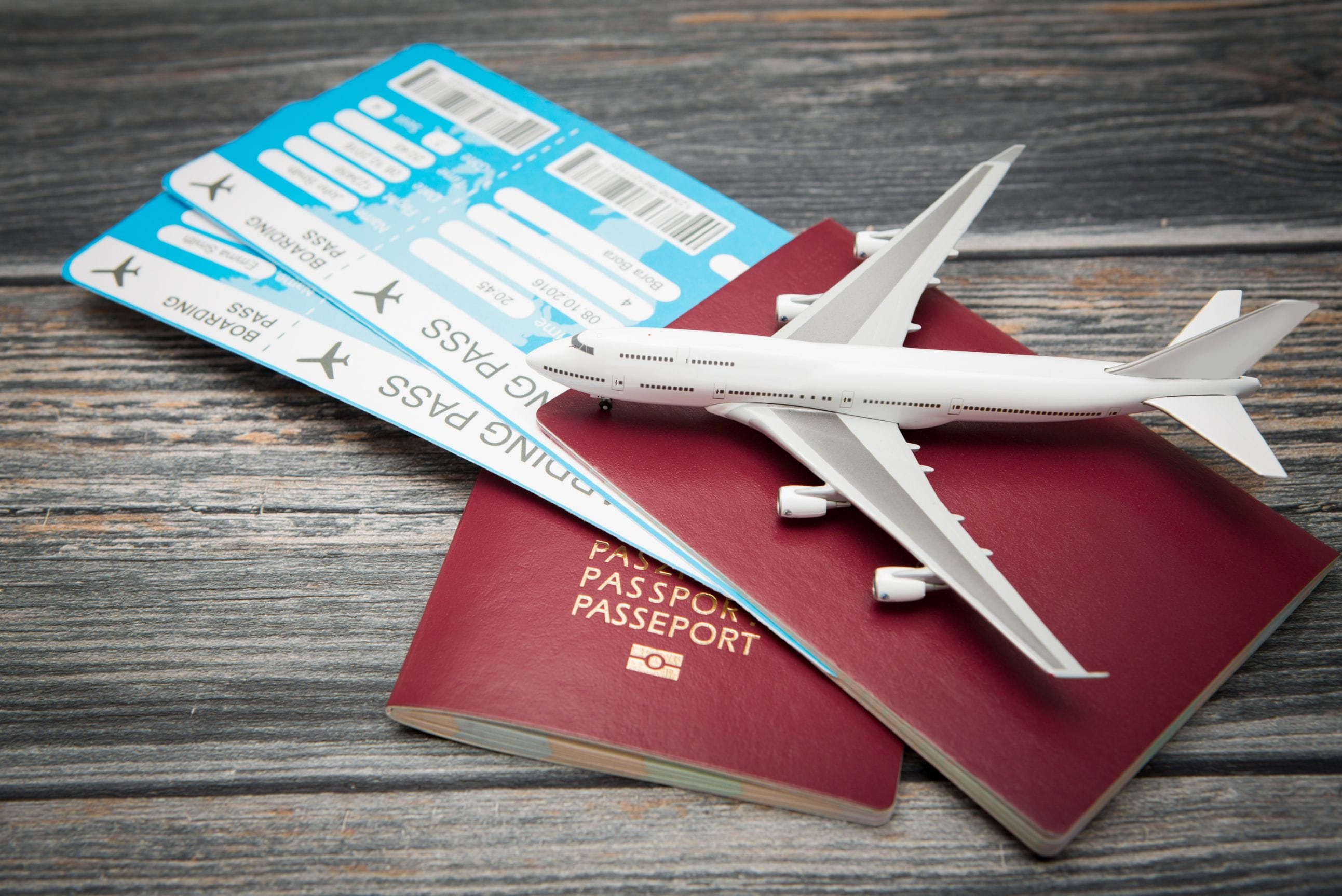 Model plane on top of passports and boarding passes.