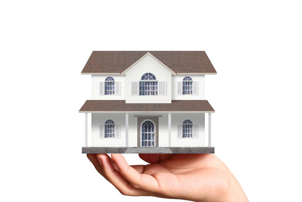 Model house resting in someone's hand.