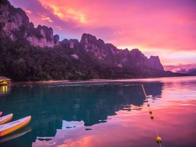 Water reflecting red sky over Khao Sok National Park in Thailand.