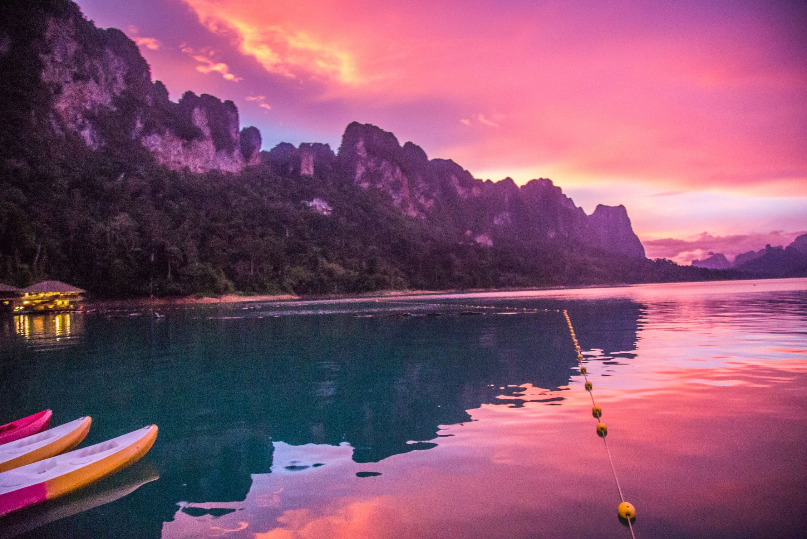 Water reflecting red sky over Khao Sok National Park in Thailand.