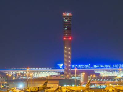 Exterior of Suvarnabhumi Airport at night in Thailand.