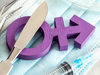 Gender-affirming symbol with medical instruments and mask.