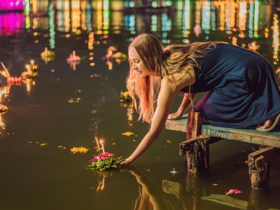 Woman floating krathong at Loy Krathong festival in Thailand.