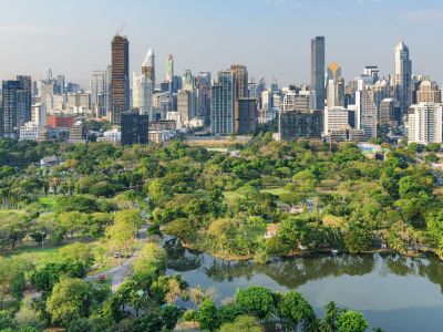 Aerial view of Lumphini Park, Bangkok, with Silom skyline.