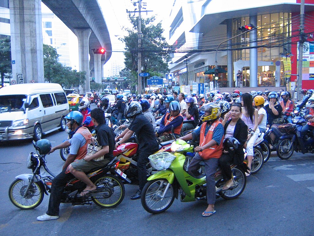 Scooters waiting at junction in Nana, Bangkok.