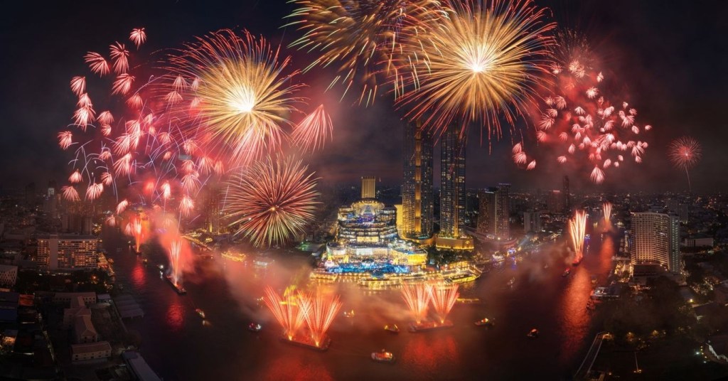 Fireworks over ICONSIAM in Bangkok during countdown.