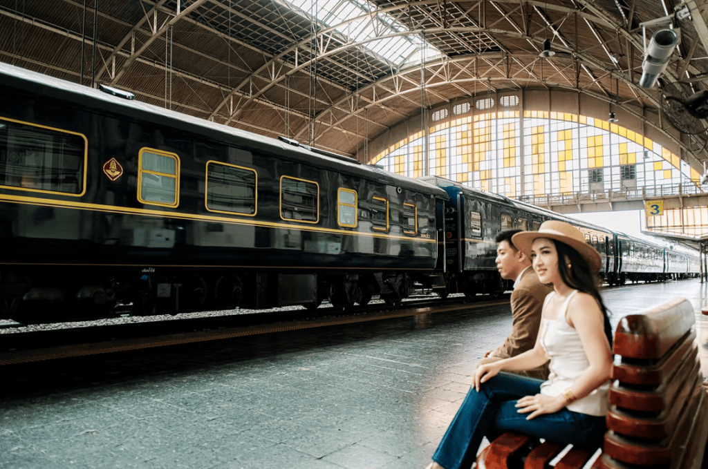 A couple of passengers admiring The Blue Jasmine train on a station platform.