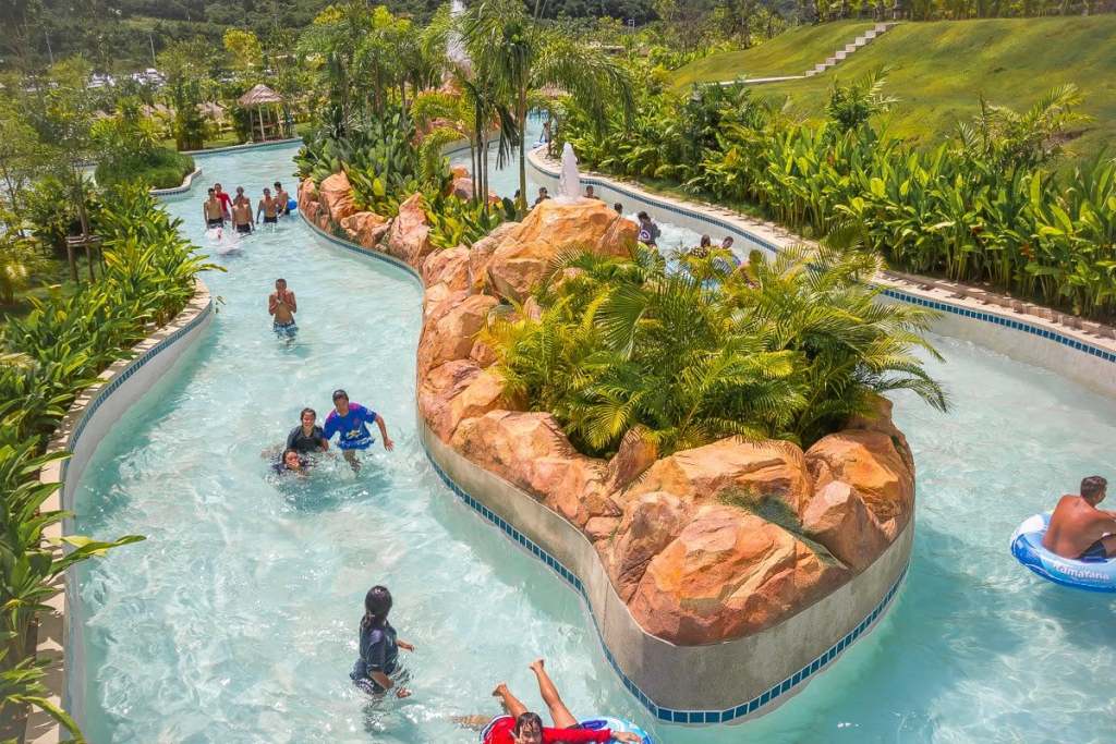 People playing in a lazy river at Ramayana Water Park in Thailand.